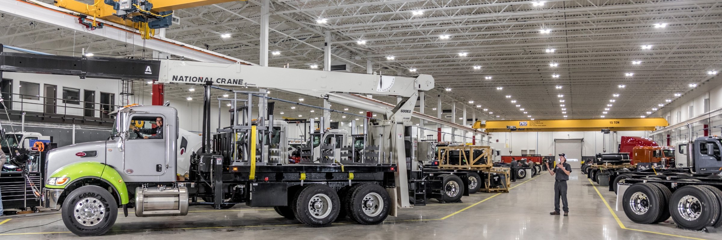 Custom Vehicle Solutions employees installing crane on truck